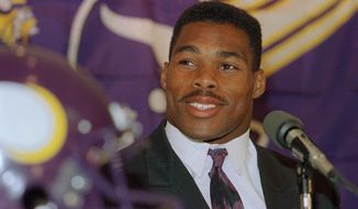 In this Oct. 13, 1989, file photo, former Dallas Cowboys running back Herschel Walker smiles as he is introduced at a news conference to announce the trade of five players and seven draft choices by the Minnesota Vikings for the leading NFC rusher, in Bloomington, Minn. (AP Photo/Jim Mone) ** FILE **