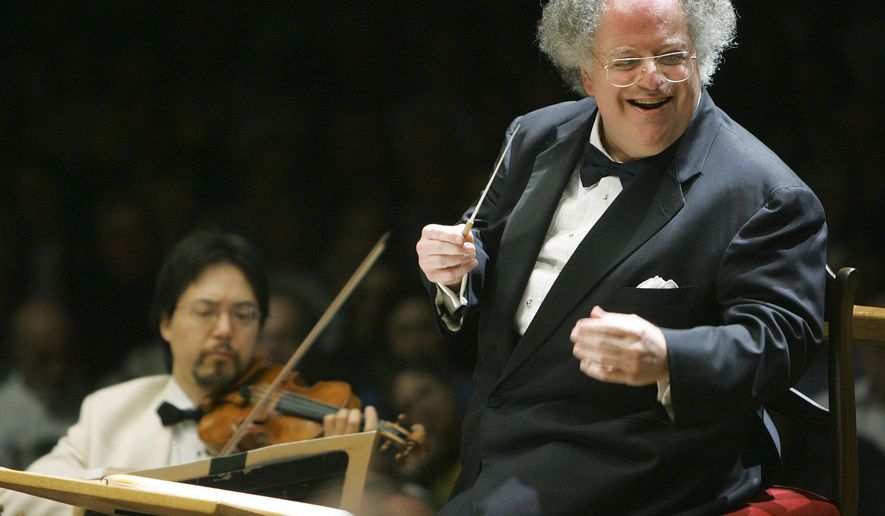 FILE - This July 7, 2006 file photo shows Boston Symphony Orchestra music director James Levine, right, conducting the symphony on its opening night performance at Tanglewood in Lenox., Mass. The Metropolitan Opera said, Thursday, April 14, 2016, that Levine will retire as music director at season's end. (AP Photo/Michael Dwyer, File)