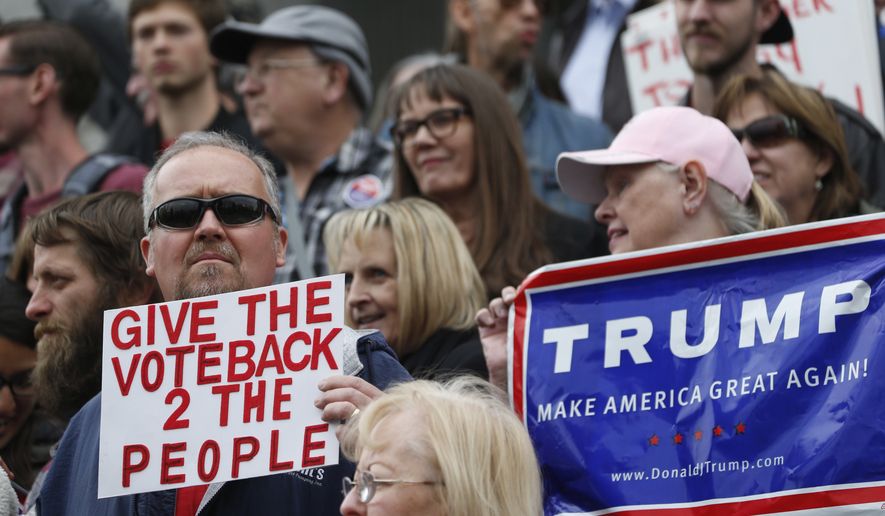 Darrin Black, left, of Thornton, Colo., holds up a placard as he joins supporters of the Republican presidential candidate Donald Trump to demonstrate on the steps of the Colorado State Capitol Friday, April 15, 2016, in downtown Denver. Colorado supporters of Trump were protesting the convoluted procedure that led Ted Cruz to sweep all the state&#39;s 34 delegates to the national convention during the state Republican assembly last weekend in Colorado Springs, Colo. (AP Photo/David Zalubowski)