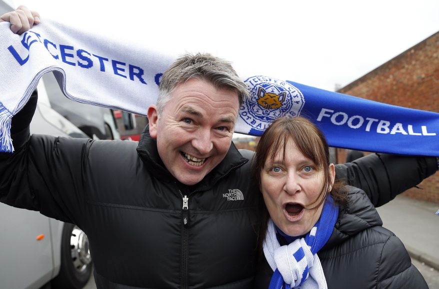 In this photo taken Saturday, March 19, 2016, English Premier League side Leicester City fans Phil and Steph Jastrzebski arrive for the English Premier League soccer match between Crystal Palace and Leicester City at Selhurst Park stadium in London. Leicester fans never expected to see their modest team have a shot at winning the Premier League this season. Phil Jastrzebski is amazed at how Leicester has soared up the standings while relying on players like Jamie Vardy and Riyad Mahrez, who collectively cost about $2 million. (AP Photo/Frank Augstein)