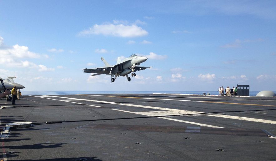 An FA-18 jet fighter takes off on the USS John C. Stennis, aircraft carrier in the South China Sea on Friday, April 15, 2016. U.S. Defense Secretary Ash Carter visited the aircraft carrier during a trip to the region. (AP Photo/Lolita C. Baldor)