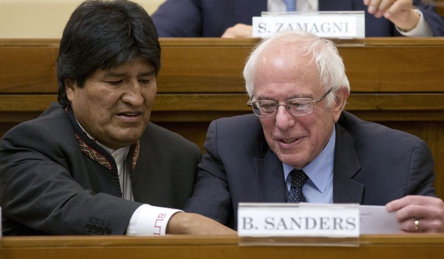 US Democratic presidential candidate, Sen. Bernie Sanders, I-Vt. right, speaks with Bolivia president Evo Morales during a conference commemorating the 25th anniversary of "Centesimus Annus," a high-level teaching document by Pope John Paul II on the economy and social justice at the end of the Cold War, at the Vatican, Friday, April 15, 2016. (AP Photo/Andrew Medichini)