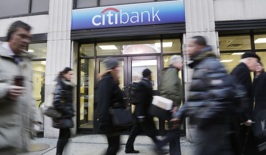 FILE - In this Thursday, Jan. 15, 2015, file photo, people walk past a branch office of Citibank, in New York. On Friday, April 15, 2016, Citigroup reports financial results. (AP Photo/Mark Lennihan, File)