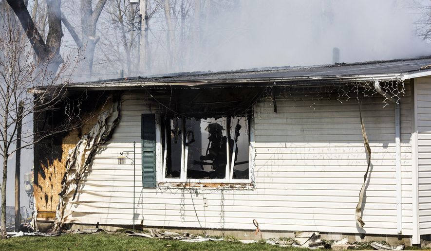 In this Thursday, April 14, 2016 photo firefighters work to extinguish a blaze at a home in Thetford Township, in Flint, Mich. At least two people were reportedly killed in the fire. (Conor Ralph /The Flint Journal-MLive.com via AP) LOCAL TELEVISION OUT; LOCAL INTERNET OUT; MANDATORY CREDIT