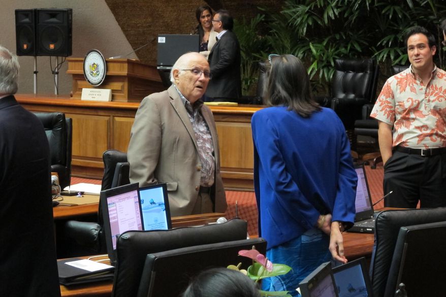 House Speaker Joseph Souki talks with representatives before the floor session on Friday, April 15, 2016 in Honolulu. Souki and legislative leaders are planning to vote to appoint a new state auditor, in a move that would direct the attention of an official who’s viewed as a strict government watchdog from the Legislature to the executive branch. (AP Photo/Cathy Bussewitz)