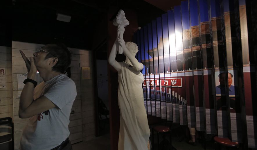 A man looks at the exhibits in the June 4th Museum in Hong Kong, Friday, April 15, 2016. The world's only museum chronicling the Chinese government's brutal 1989 crackdown on student protesters in Beijing's Tiananmen Square say it faces closure because of a legal dispute, its Hong Kong operators said Friday. (AP Photo/Kin Cheung)