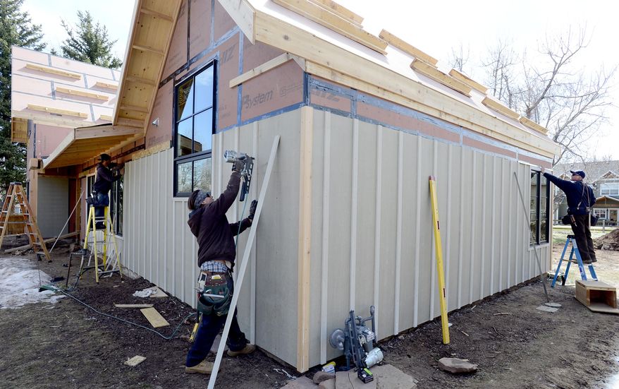 ADVANCE FOR RELEASE SATURDAY, APRIL 16, 2016, AND THEREAFTER- In this April 1, 2016, photo, Nick Carbones, far left, Todd Ryon, and Trevor Cavazos, of Cavazos Design and Build, work on a new home in Boulder, Colo. (Cliff Grassmick/Daily Camera via AP) NO SALES; MANDATORY CREDIT