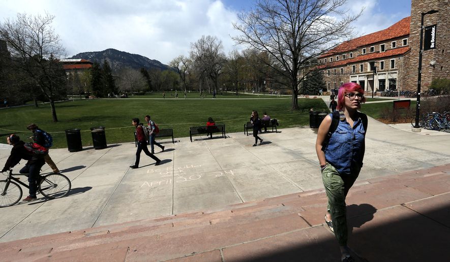 In this April 20, 2015 file photo, students walk to and from classes on the campus quad of the University of Colorado, in Boulder, Colo. There&#39;s good news and bad news in the $27 billion state budget up for debate Thursday, March 31, 2016, in the Colorado House. Schools and colleges aren’t getting budget cuts. Colleges and vocational training programs fared well, too, getting an extra $14.5 million despite warnings from legislative Democrats that Colorado’s 31 public institutions of higher education would see budget cuts requiring tuition hikes. (AP Photo/Brennan Linsley, File) — FILE  