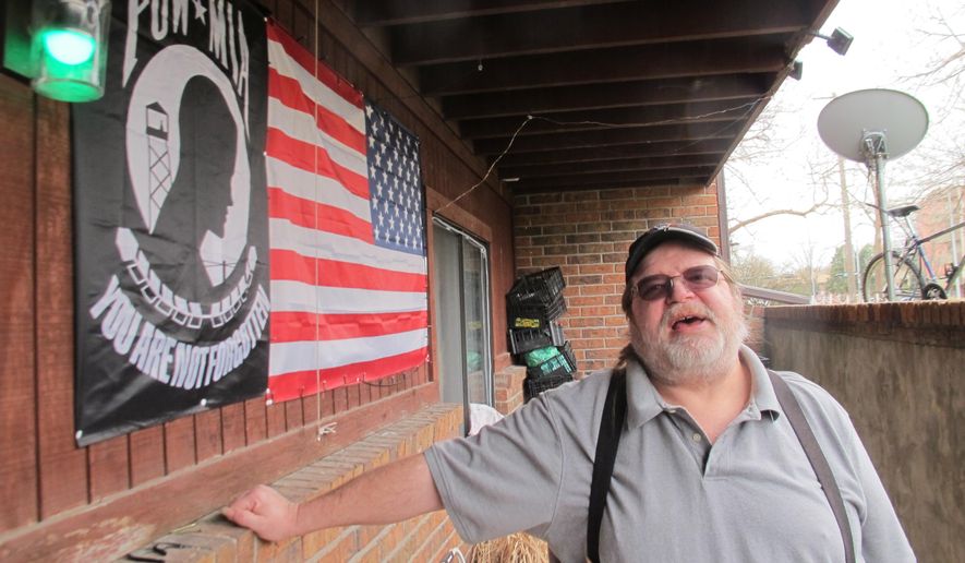 In this Monday, March 21, 2016, photo, Ronald Tillman stands outside of his apartment in Lincoln, Neb. Tillman, a Navy veteran, spent three years in prison for selling morphine pills to a police informant, and is now ineligible for food stamps despite his bipolar disease and a debilitating back injury that have made it hard for him to work. Nebraska is among a dwindling number of states that still enforce a lifetime ban on drug offenders receiving food stamps. (AP Photo/Grant Schulte)