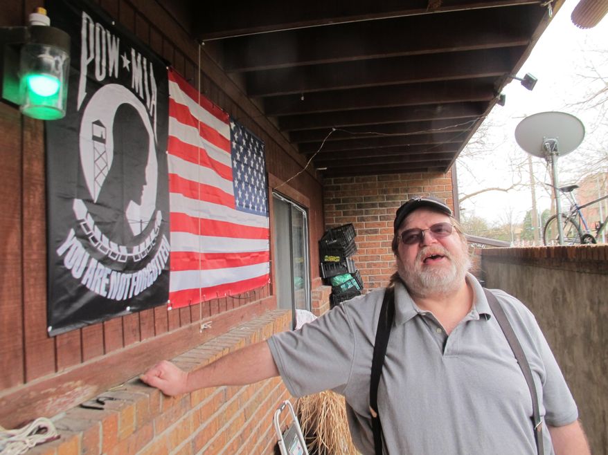 In this Monday, March 21, 2016, photo, Ronald Tillman stands outside of his apartment in Lincoln, Neb. Tillman, a Navy veteran, spent three years in prison for selling morphine pills to a police informant, and is now ineligible for food stamps despite his bipolar disease and a debilitating back injury that have made it hard for him to work. Nebraska is among a dwindling number of states that still enforce a lifetime ban on drug offenders receiving food stamps. (AP Photo/Grant Schulte)