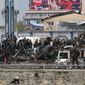 Afghan security forces inspect the site of a Taliban-claimed deadly suicide attack in Kabul, Afghanistan, Tuesday that killed 28 people. (Associated Press)
