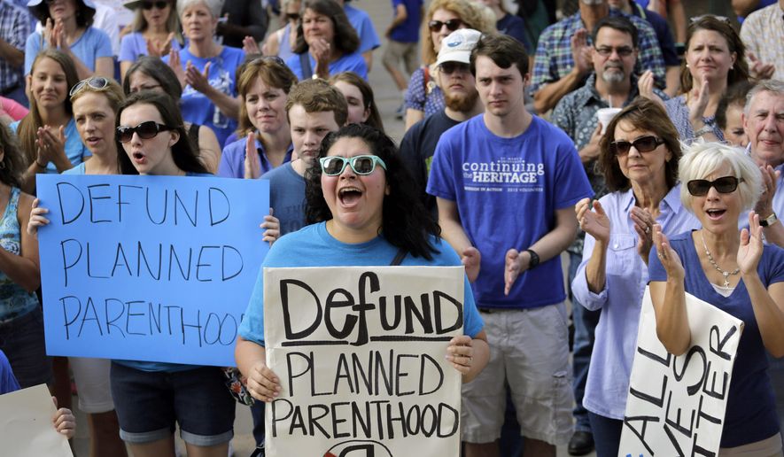 Anti-abortion activists rally in Austin, Texas, to condemn the use in medical research of tissue samples obtained from aborted fetuses. (Associated Press) ** FILE **