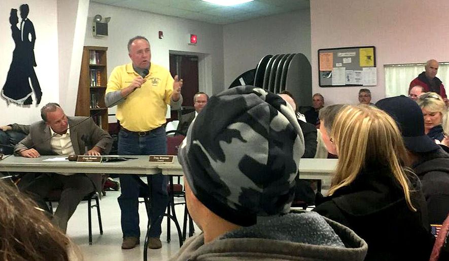 ADVANCE FOR SATURDAY APRIL 23 AND THEREAFTER - In a Nov. 25, 2015 photo, Councilman Joe Glasson speaks to residents during a Bristol Township town hall meeting about recovery houses, in Bristol, Pa. Property values, along with public safety, over-saturation and overall quality of life are among the main concerns of some residents of Bristol Township, which has the highest concentration of these houses in Bucks County. (Jenny Wagner/Bucks County Courier Times via AP) MANDATORY CREDIT