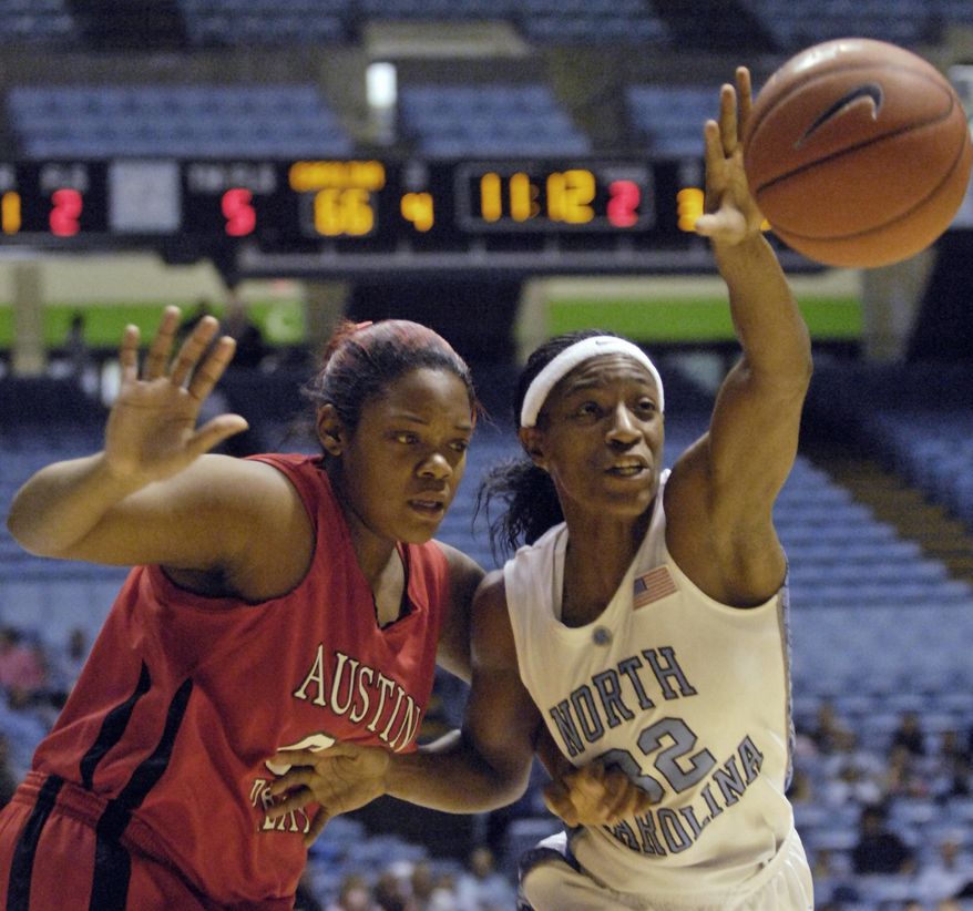 FILE - In this Tuesday, Dec. 30, 2008 file photo, North Carolina&#x27;s Rashanda McCants, right, reaches for a loose ball over Austin Peay&#x27;s Jasmine Rayner, left, during the second half of an NCAA college women&#x27;s basketball game in Chapel Hill, N.C.  An attorney representing McCants and Devon Ramsay, two ex-North Carolina athletes says the school and NCAA are both responsible for UNC’s long-running academic fraud scandal that he says denied athletes a quality education. (AP Photo/Sara D. Davis, File)