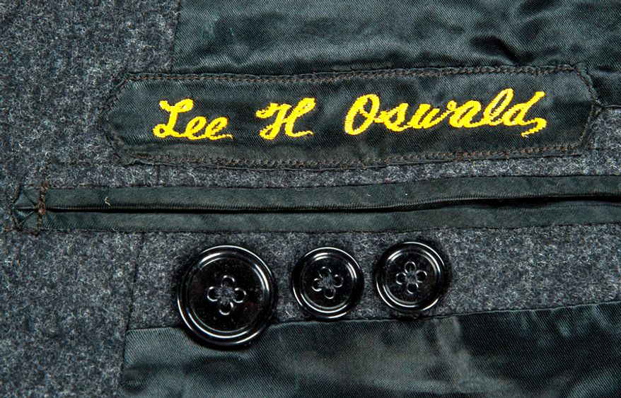 The baby clothes of the late John Kennedy, Jr. are among Kennedy-related items going up for auction. The lotsalso includes Lee Harvey Oswald's suit; a personalized stitched detail is shown here. (Goldin Auctions)
