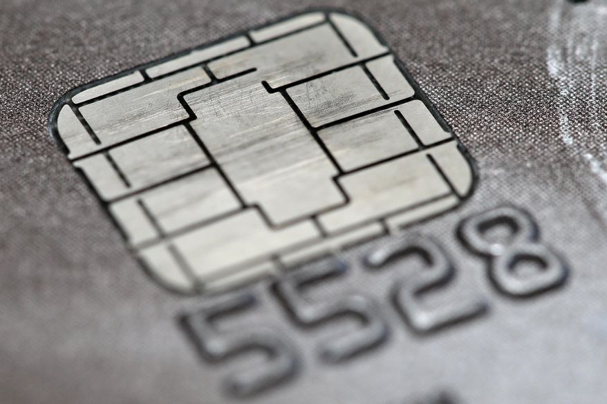 FILE -This June 10, 2015 photo shows a chip credit card in Philadelphia. Visa says its improving its smart chip-embedded cards, which have been the source of grumbling from businesses and customers forced to wait for transactions to go through. The company said Tuesday, April 19, 2016 that Quick Chip for EMV will let customers dip and remove cards, usually in two seconds or less, without waiting for purchases to be finalized. (AP Photo/Matt Rourke)