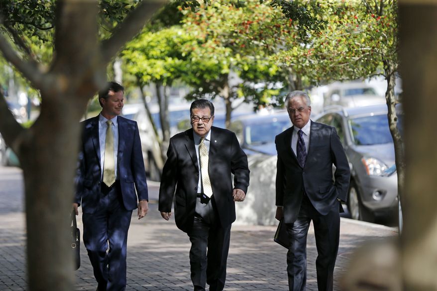Former New Orleans Police Former Sgt. Arthur Kaufman, center, arrives at Federal Court in New Orleans, Wednesday, April 20, 2016. Five former New Orleans police officers are expected to enter pleas to reduced charges in the deadly shootings on a bridge in the days that followed Hurricane Katrina in 2005. Kaufman, who was not involved in the shooting, faces a new trial in the cover-up alone. (AP Photo/Gerald Herbert)