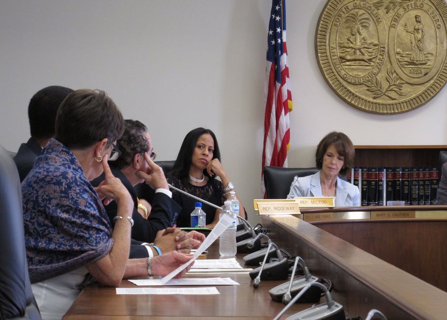 South Carolina Rep. Mia McLeod, center, listens to lawmakers discuss her bill requiring a 24-hour waiting period for men to get a Viagra prescription on Wednesday, April 20, 2016, in Columbia, South Carolina. The Columbia Democrat said her bill was a tongue-in-cheek response to all of the regulations South Carolina's male-dominated Legislature places on abortions. (AP Photo/Jeffrey Collins)
