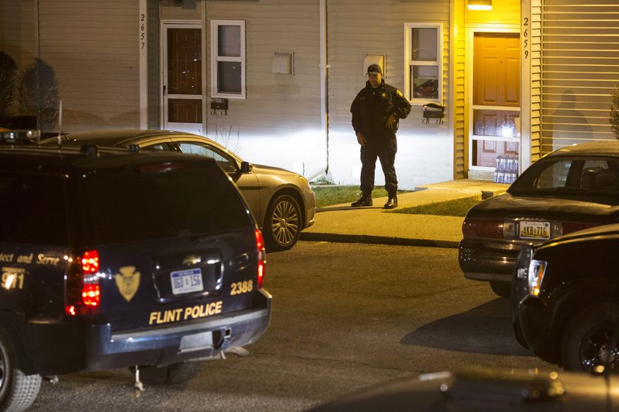 Police respond to a fatal shooting Tuesday, April 19, 2016, in Flint, Mich. (Conor Ralph/The Flint Journal-MLive.com via AP) LOCAL TELEVISION OUT; LOCAL INTERNET OUT; MANDATORY CREDIT