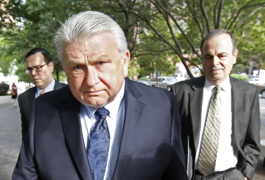 Harry Morel, a former district attorney for St. Charles Parish, La., arrives with his attorney Ralph Capitelli, right, at Federal Court in New Orleans, Wednesday, April 20, 2016. Morel is charged with obstructing a federal investigation. A bill of information filed by prosecutors said he harassed an unidentified witness in a federal grand jury investigation. (AP Photo/Gerald Herbert)