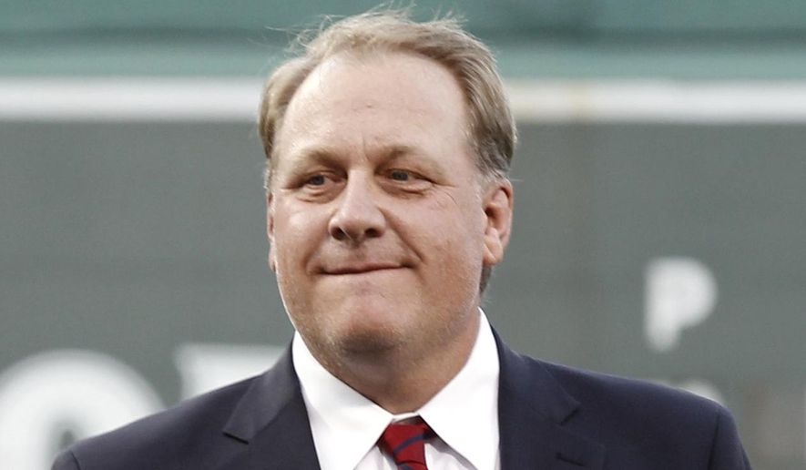 Former Boston Red Sox pitcher Curt Schilling looks on after being introduced as a new member of the Boston Red Sox Hall of Fame before a baseball game between the Red Sox and the Minnesota Twins at Fenway Park in Boston on Aug. 3, 2012. (Associated Press) **FILE**