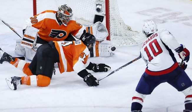 Philadelphia Flyers&#x27; Michal Neuvirth (30) and Andrew MacDonald (47) defend a shot by Washington Capitals&#x27; Mike Richards (10) during the third period of Game 4 in the first round of the NHL Stanley Cup hockey playoffs, Wednesday, April 20, 2016, in Philadelphia. Philadelphia won 2-1. (AP Photo/Matt Slocum)
