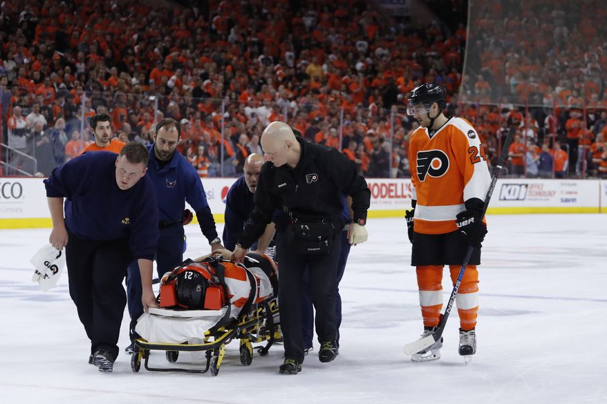 Philadelphia Flyers' Scott Laughton is taken off the ice after an injury during Game 4 in the first round of the NHL Stanley Cup hockey playoffs against the Washington Capitals, Wednesday, April 20, 2016, in Philadelphia. (AP Photo/Matt Slocum)
