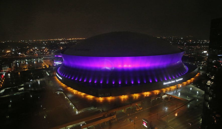 The Mercedes-Benz Superdome is lit up in the color purple in New Orleans, Thursday, April 21, 2016, to honor pop legend Prince, who died today. (AP Photo/Gerald Herbert)