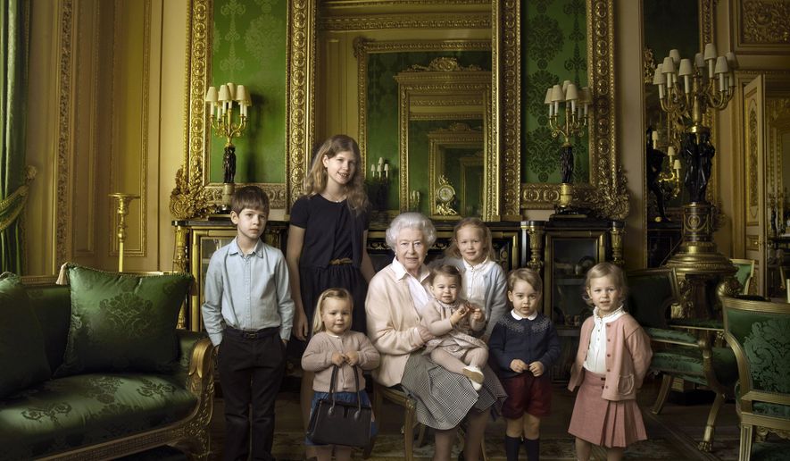 This official photograph, released by Buckingham Palace on Wednesday April 20, 2016, to mark her 90th birthday, shows Queen Elizabeth II with her five great-grandchildren and her two youngest grandchildren in the Green Drawing Room, part of Windsor Castle's semi-State apartments in Windsor England. The children are: James, Viscount Severn, 8-years-old, left, and Lady Louise, 12-years-old, second left, the children of The Earl and Countess of Wessex; Mia Tindall, holding The Queen's handbag, the two year-old-daughter of Zara and Mike Tindall; Savannah 5-years-old, third right, and Isla Phillips, 3-years-old, right, daughters of The Queen's eldest grandson Peter Phillips and his wife Autumn; Prince George, 2-years-old, second right, and in The Queen's arms and in the tradition of Royal portraiture, the youngest great-grandchild, Princess Charlotte, 11-months-old, children of Prince William and Kate Duchess of Cambridge. (© 2016 Annie Leibovitz via AP) MANDATORY CREDIT