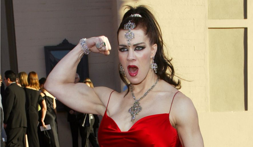 In this Nov. 16, 2003 file photo, Joanie Laurer, former pro wrestler known as Chyna, flexes her bicep as she arrives at the 31st annual American Music Awards, in Los Angeles. Chyna, the WWE star who became one of the best known and most popular female professional wrestlers in history in the late 1990s, has died at age 45. Los Angeles County coroner&amp;#8217;s Lt. Larry Dietz says Chyna, whose real name is Joan Marie Laurer, was found dead in Redondo Beach on Wednesday, April 20, 2016. (AP Photo/Kevork Djansezian, File) — FILE