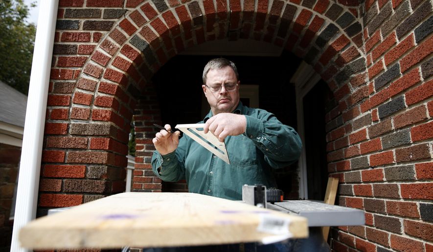 In this Oct. 23, 2015 photo, Glenn Billingsley takes a measurement on a piece of wood as part of a bathroom repair at a client's duplex in Dallas. For decades, Billingsley had no name for his disease, one of the most commonly misunderstood mental illnesses. He now receives help from Metrocare Services, which treats about 12,000 people with bipolar disorder every year. (Rose Baca/The Dallas Morning News via AP) MANDATORY CREDIT; MAGS OUT; TV OUT; INTERNET USE BY AP MEMBERS ONLY; NO SALES