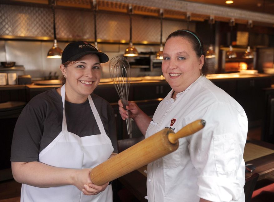 In this April 11, 2016 photo, from left, pastry chef's Lisa O'Connor and Amanda Williams pose for a photograph at Six Penn Kitchen, in Pittsburgh. The pastry chefs have been at Six Penn Kitchen from when it first opened almost 11 years ago. While O'Connor focuses on baking breads and desserts for lunch, Williams comes in at 5 p.m. and works until 1 a.m., spearheading the dinner scene. (Nate Guidry/Pittsburgh Post-Gazette via AP) MAGS OUT; MONESSEN OUT; KITTANNING OUT; CONNELLSVILLE OUT; GREENSBURG OUT; TARENTUM OUT; NORTH HILLS NEWS RECORD OUT; BUTLER OUT; MANDATORY CREDIT