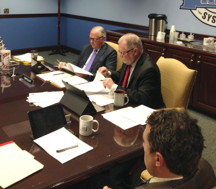 Thomas K. Elliott, left, presides at a Kentucky Retirement Systems board of trustees meeting on Thursday, April 21, 2016, in Frankfort, Ky. Elliott took his seat at the head of the board table in defiance of Gov. Matt Bevin's order removing him from the board. Republican Gov. Matt Bevin removed the chairman of the Kentucky Retirement Systems board of trustees Wednesday, saying one of the country's worst-funded public pension systems needs a "fresh start." Kentucky Retirement Systems Executive Director William Thielen is on the right. (AP Photo/Bruce Schreiner)