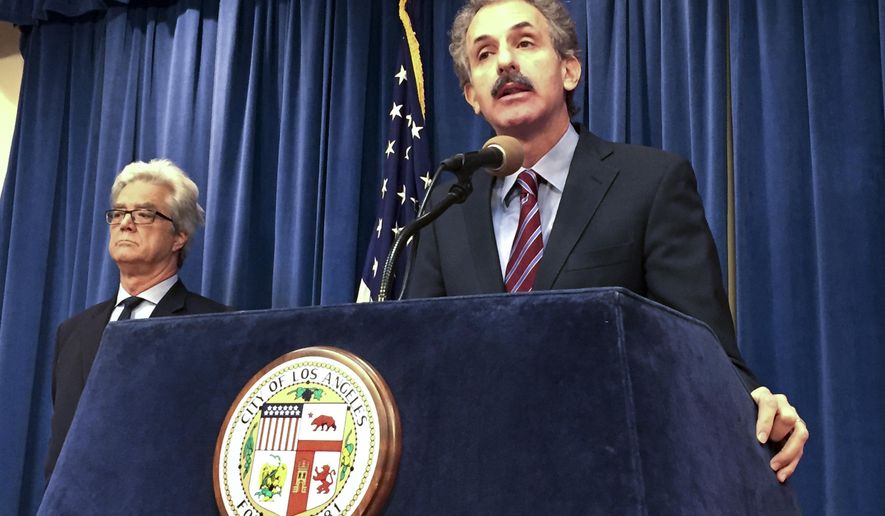 Los Angeles City Attorney Mike Fueur, center, and Deputy City Attorney Will Jay Pirkey, left, talk during a news conference on Thursday, April 21, 2016 at City Hall in Los Angles about patient dumping. A fourth Los Angeles-area hospital in less than three years has settled a civil lawsuit over a chronic problem in the nation's second-largest city, dumping homeless patients on the streets after they've been discharged, sometimes while still needing medical attention. (AP Photo/Amanda Lee Myers)