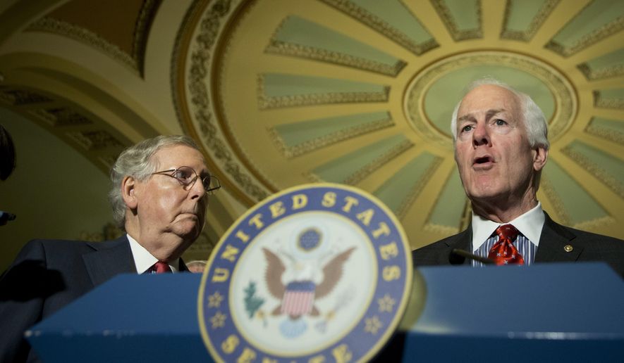 Senate Majority Leader Mitch McConnell of Ky. listens at left as Senate Majority Whip John Cornyn of Texas speaks to reporters on Capitol Hill in Washington, Tuesday, April 19, 2016. (AP Photo/Manuel Balce Ceneta)