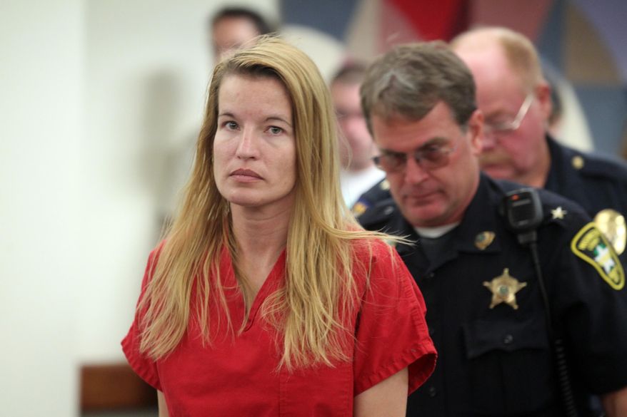 FILE- In this Aug. 10, 2015, file photo, Jody Herring is led out of court after her arraignment in Vermont Superior Court in Barre, Vt. A lawyer for Herring, a Vermont woman charged with killing a social worker and three of her own relatives after losing custody of her daughter, says she's incompetent to stand trial. (Toby Talbot/Times Argus via AP, Pool, File)