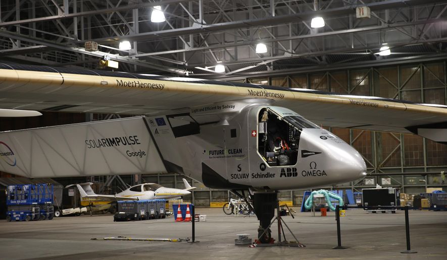 Ground crew prepare for the departure of the Solar Impulse 2 solar plane from the Kalaeloa Airport, Thursday, April 21, 2016, in Kapolei, Hawaii. The Solar Impulse team landed in the islands in July after a record-breaking flight from Japan. (AP Photo/Marco Garcia)