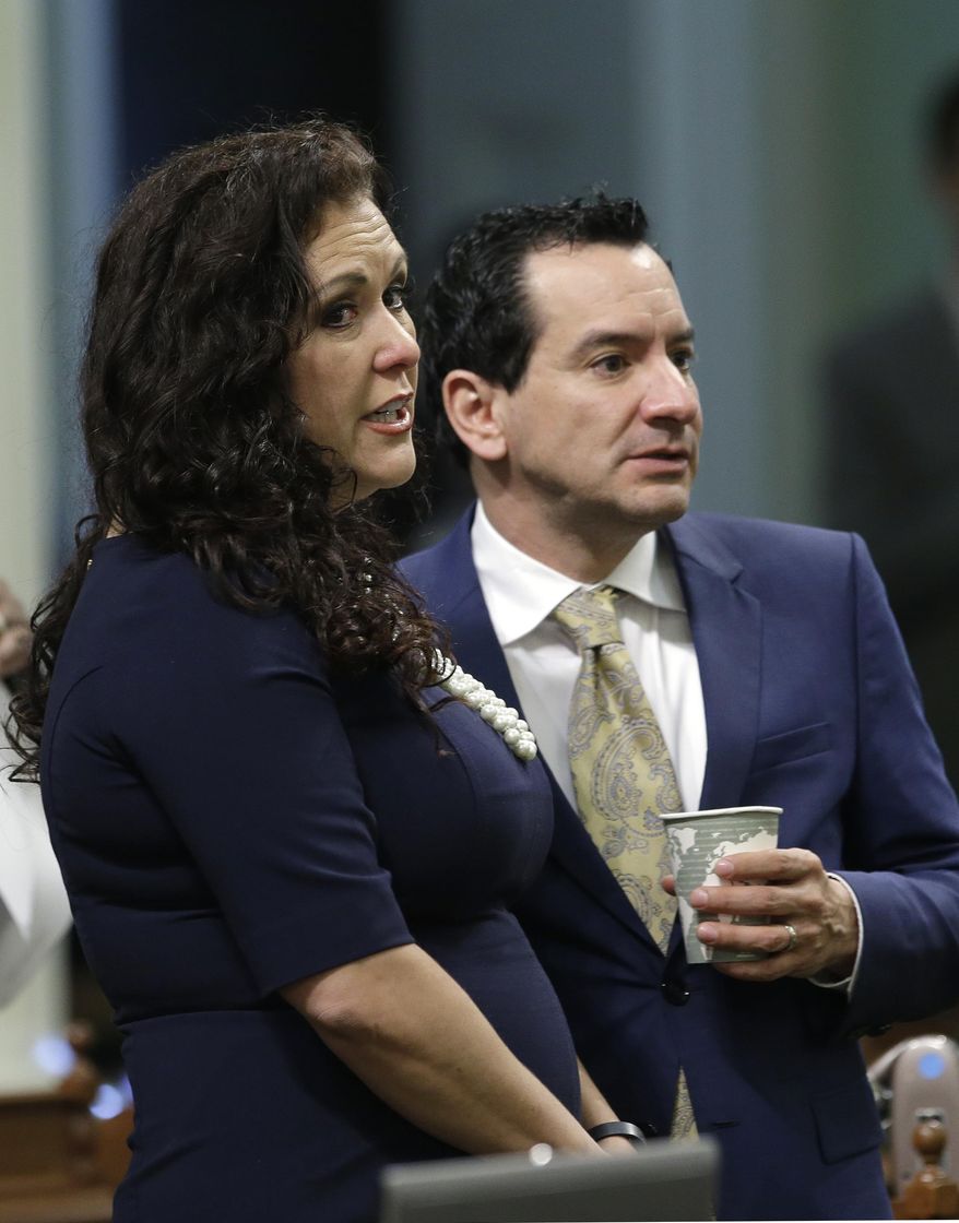 Assemblywoman Lorena Gonzalez, D-San Diego, talks with Assembly Speaker Anthony Rendon, D-Paramount, during the Assembly session, Thursday, April 21, 2016, in Sacramento, Calif. Gonzalez announced Thursday, that she has withdrawn her bill, AB 1727, that would allow independent contractors to unionize. (AP Photo/Rich Pedroncelli)