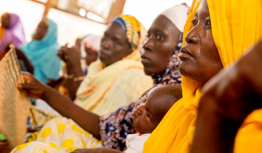 Displaced women gather together to meet with U.S. Ambassador to the United Nations Samantha Power as she visits the Malkohi Internally Displaced Person Camp in Yola, Nigeria, Friday, April 22, 2016. Power is traveling to Cameroon, Chad, and Nigeria to highlight the growing threat Boko Haram poses to the Lake Chad Basin region. (AP Photo/Andrew Harnik)