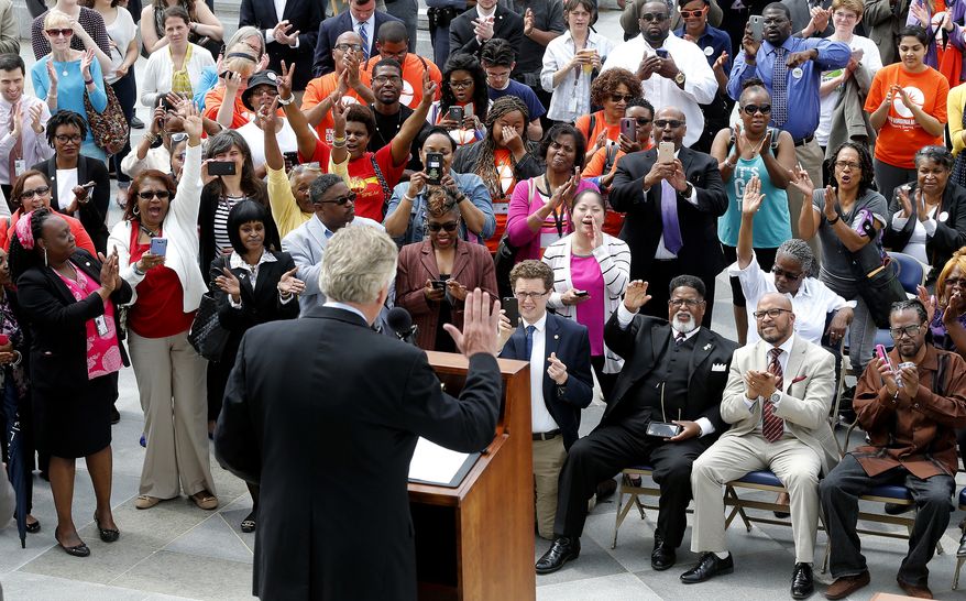The crowd cheers during Gov. Terry McAuliffe's announcement on the restoration of rights to felons in Virginia at the Capitol in Richmond Va., Friday, April 22, 2016. More than 200,000 convicted felons will be able to cast ballots in the swing state of Virginia in November's election under a sweeping executive order by McAuliffe announced Friday that restores their rights to vote and run for office. (Mark Gormus /Richmond Times-Dispatch via AP) MANDATORY CREDIT