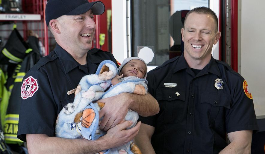 In this March 31, 2016 photo, Collinsville, Ill., firefighters and paramedics Danny Gulledge, left, and Chris Castens, talk about how they helped Stacey Whitson deliver her son, DaCorrione on Feb. 25. (Derik Holtmann/Belleville News-Democrat via AP) MANDATORY CREDIT