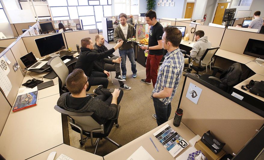 ADVANCE FOR THE WEEKEND OF APRIL 23-24 AND THEREAFTER - In a March 30, 2016 photo, Domo Technologies employees hold a standing meeting in American Fork, Utah. In the world of business, a unicorn is a company, usually a startup that may not have an established performance record, with a stock market value or estimated valuation of more than $1 billion. Utah is home to at least six unicorns including Domo Technologies. (Jeffrey D. Allred/The Deseret News via AP) SALT LAKE TRIBUNE OUT; MAGS OUT; MANDATORY CREDIT; TV OUT