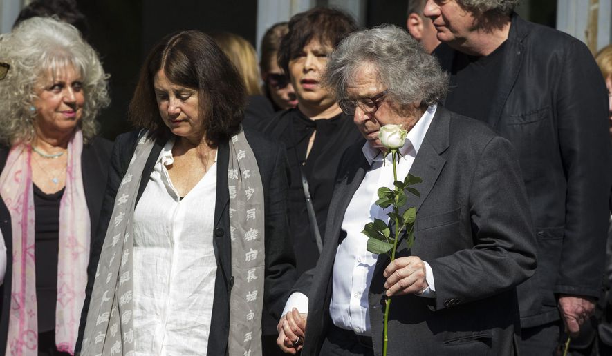 Hungarian writer Gyoergy Konrad, right, attends the funeral ceremony of Nobel Prize winner Hungarian writer Imre Kertesz in the Fiume Street National Graveyard in Budapest, Hungary, Friday, April 22, 2016. Kertesz died at his Budapest home on March 31 at age 86. (Zsolt Szigetvary/MTI via AP)