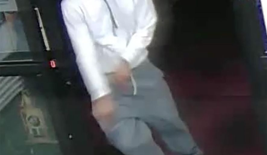 In this video image released by the Las Vegas Metropolitan Police Department one of the suspects involved in a liquor store robbery that left the store clerk dead exits the store in southwest Las Vegas on Monday night April 18, 2016. The three suspects involved are described as men in their 20s. Two were armed with handguns. (Las Vegas Metropolitan Police Department via AP)