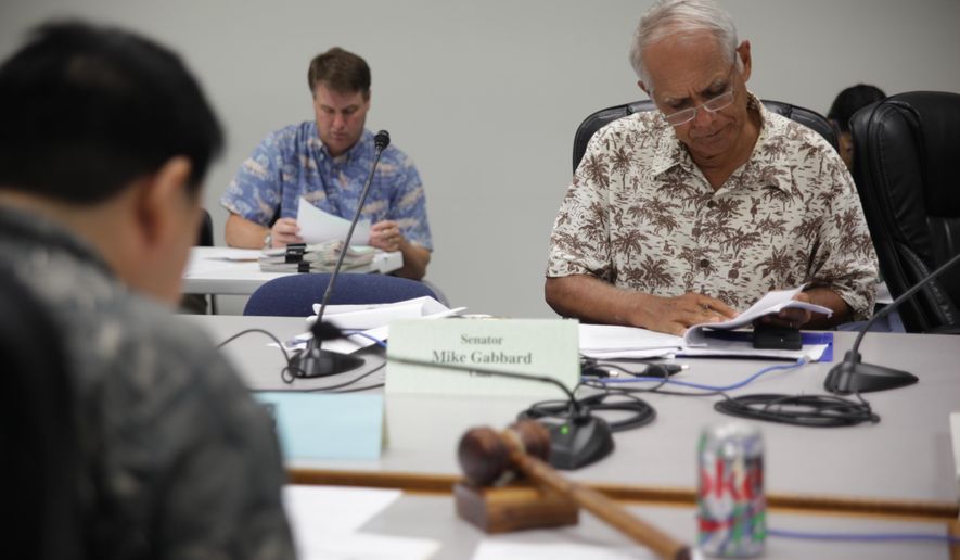 Hawaii Sen. Mike Gabbard met with lawmakers to discuss a bill that would give money to fight a deadly forest disease during a hearing at the State Capitol on Friday, April 22, 2016, in Honolulu. Also known as rapid ohia death, the disease has infected thousands of acres of native forests on the Big Island and is quickly spreading. (AP Photo/Marina Riker)