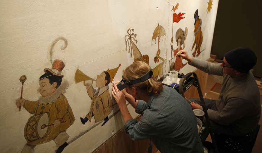 FILE - In this Jan. 31, 2011 file photo, mural paintings conservator Cassie Myers and conservation technician Lee Dunsmore with Milner + Carr Conservation LLC perform a conservation treatment on Maurice Sendak's 1961 The Chertoff Mural at the Rosenbach Museum & Library in Philadelphia. "The Chertoff Mural" will go on public view starting June 11, 2016. Sendak painted it in 1961 for the children of his friends Lionel and Roslyn Chertoff in their New York City apartment. (AP Photo/Matt Rourke)