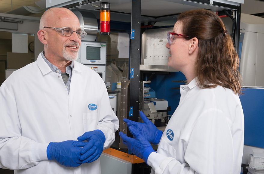 This April 13, 2016, photo provided by Pfizer shows Pfizer Discovery Medicinal Chemists Jotham Coe, left, and Jennifer Young in Groton, Conn. Seven years after U.S. regulators slapped their strictest warning on two popular smoking-cessation medicines, citing risks of suicidal behavior, a large international study found no such risk. Now Chantix maker Pfizer and Zyban maker GlaxoSmithKline hope the Food and Drug Administration, which ordered them to do the study, will remove the so-called "black box warnings" put on their prescription drugs due to anecdotal patient reports of serious psychiatric side effects. (Pfizer via AP) MANDATORY CREDIT