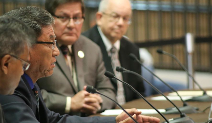 Navajo Nation President Russell Begaye, second from left, testifies before U.S. Sen. John McCain and U.S. Sen. John Barrasso, head of the Senate Committee on Indian Affairs, about actions by the Environmental Protection Agency that led to a mine spill polluting rivers in three Western states last summer, at the Phoenix city council chambers Friday, April 22, 2016. (AP Photo/Ryan Van Velzer)