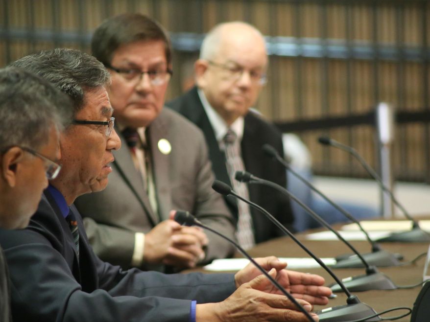 Navajo Nation President Russell Begaye, second from left, testifies before U.S. Sen. John McCain and U.S. Sen. John Barrasso, head of the Senate Committee on Indian Affairs, about actions by the Environmental Protection Agency that led to a mine spill polluting rivers in three Western states last summer, at the Phoenix city council chambers Friday, April 22, 2016. (AP Photo/Ryan Van Velzer)