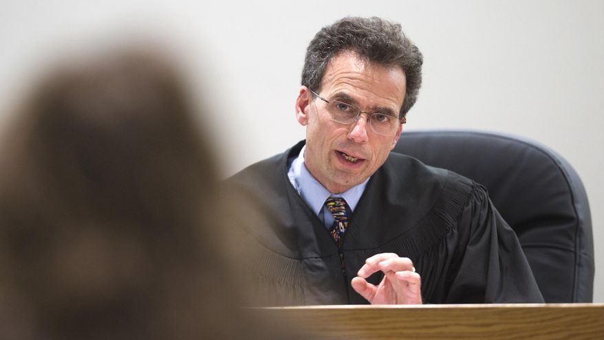 In this Wednesday, April 13, 2016 photo, Juneau District Court Judge Keith Levy speaks to a Juneau resident during an arraignment hearing in Juneau, Alaska. Judge Levy is retiring in October after almost 12 years as one of two district judges in Juneau. (Michael Penn/The Juneau Empire via AP) MANDATORY CREDIT